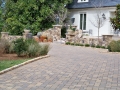 paver driveway with cobble edging and fieldstone walls and columns