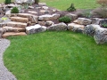boulder retaining wall creating planting pockets, fieldstone slab steps