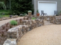 fieldstone retaining walls, prime and seal parking court, and stone slab steps