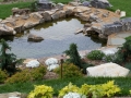 natural swim pond looking down from 8' tall boulder retaining wall